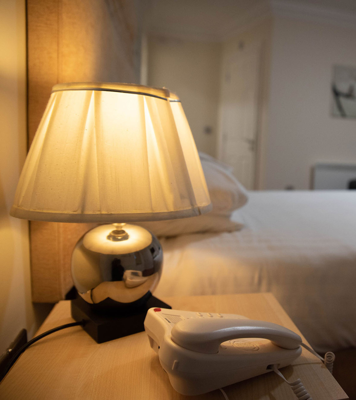 elegant room at the Clarendon with bedside lamp and telephone